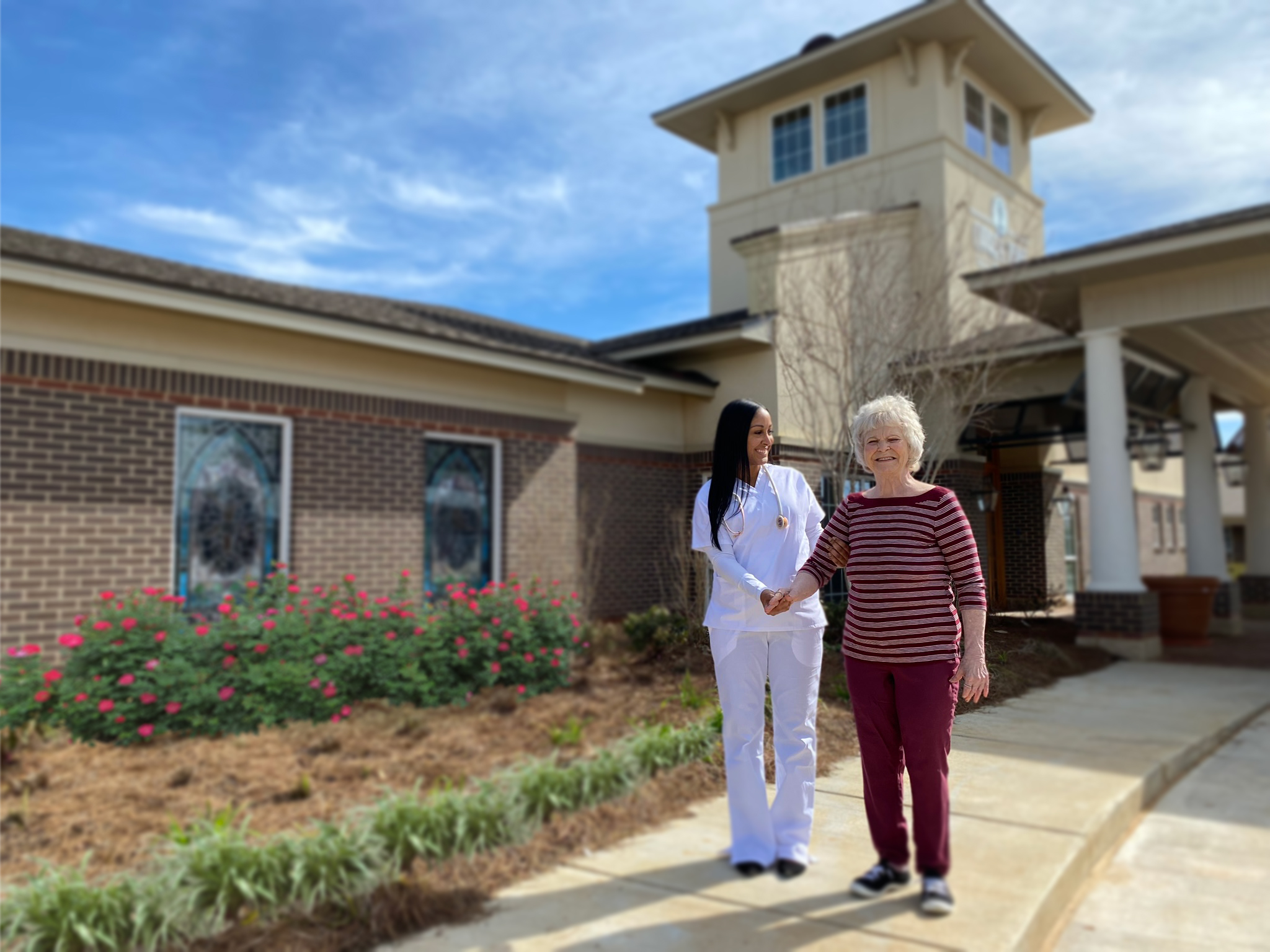 Nurse and woman walking outside