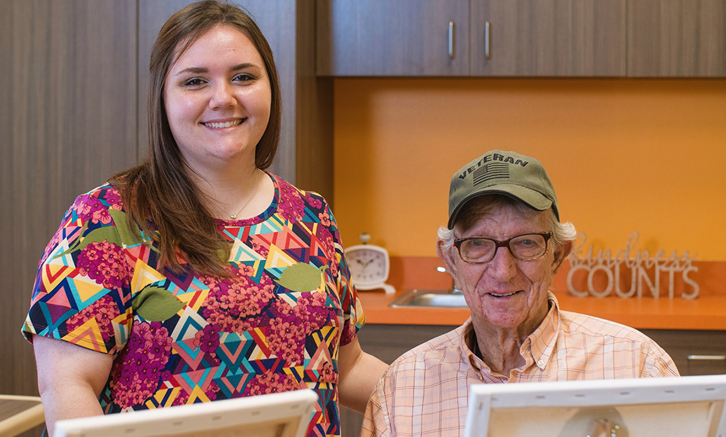 Woman smiling next to veteran